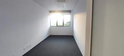 GLS — office space with carpet and large windows