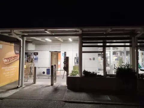 INA — petrol station shop frontage at night