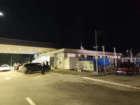 INA — approach to an INA petrol station at night