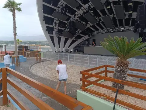 Papaya — cleaning a surface beside an outdoor pool