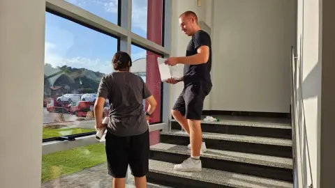 Transeuro Adria — two team members cleaning a large window